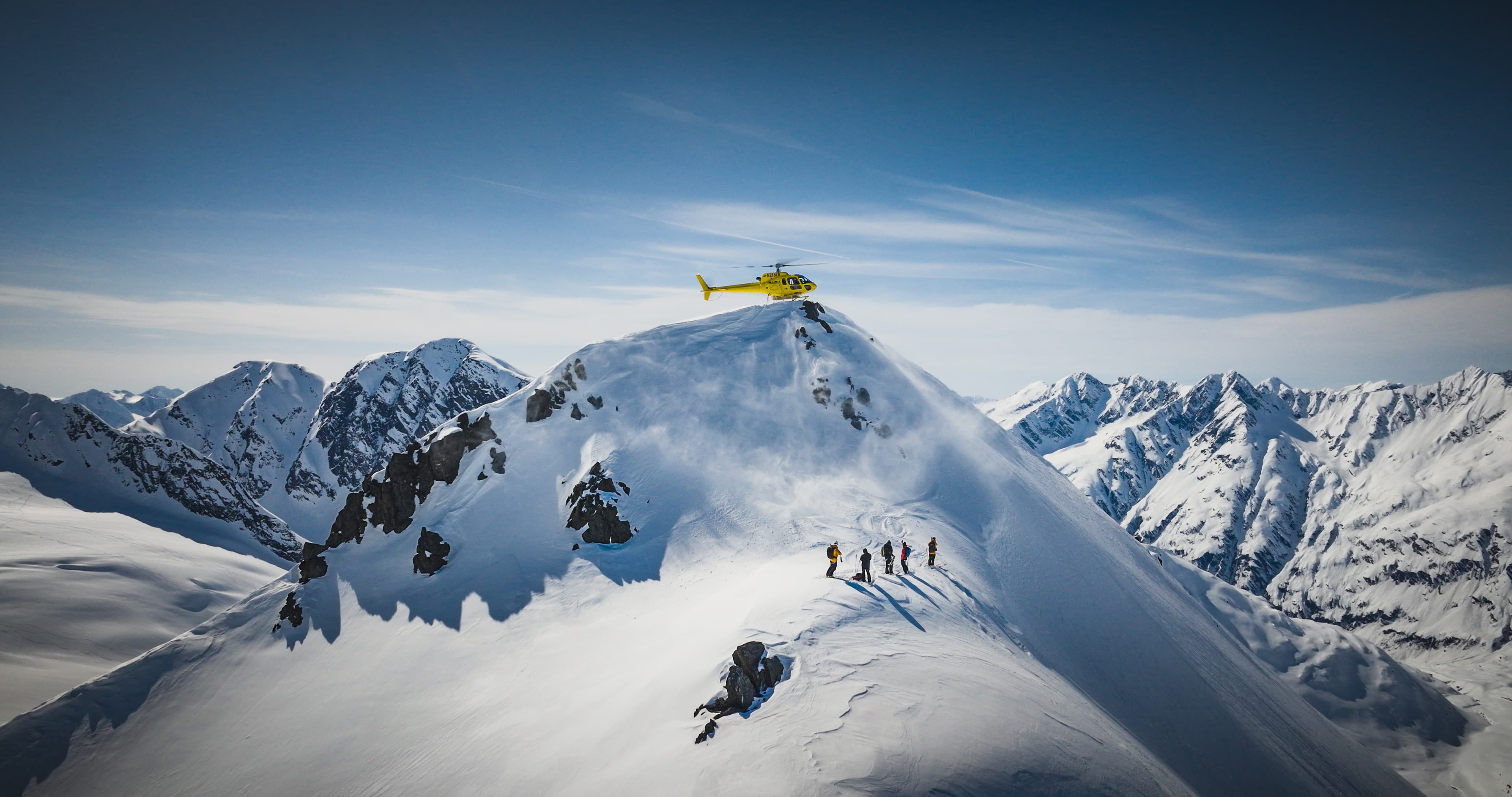 Helicopter skiing on a snow ridge in Antarctica